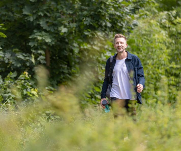 man walking through a field