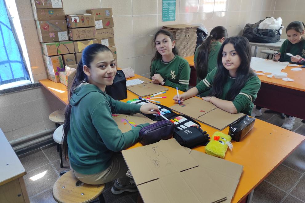 Children crafting the blackboard erasers and decorating the boxes to send them to local schools