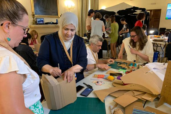 Workshop of AlElieh with participants around the table upcycling cardboard.