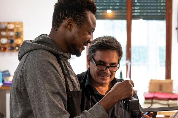 Two men crafting the leather products