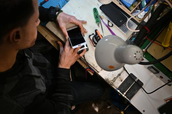 Worker fixing a broken mobile phone