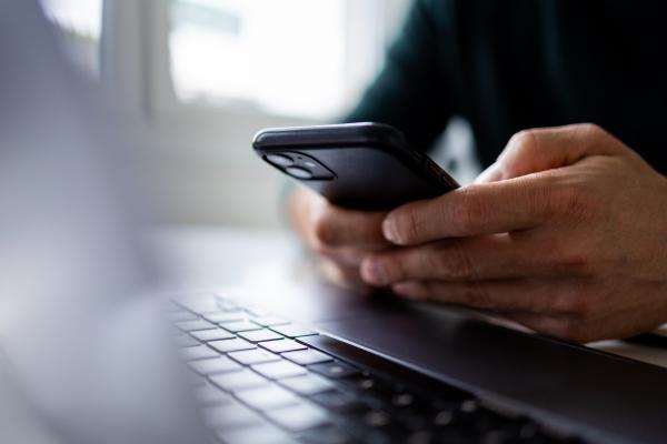 Close up of a man's hand using a mobile phone