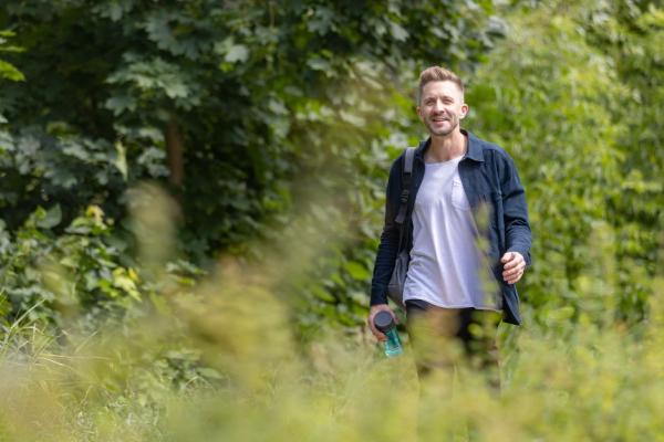 man walking through a field